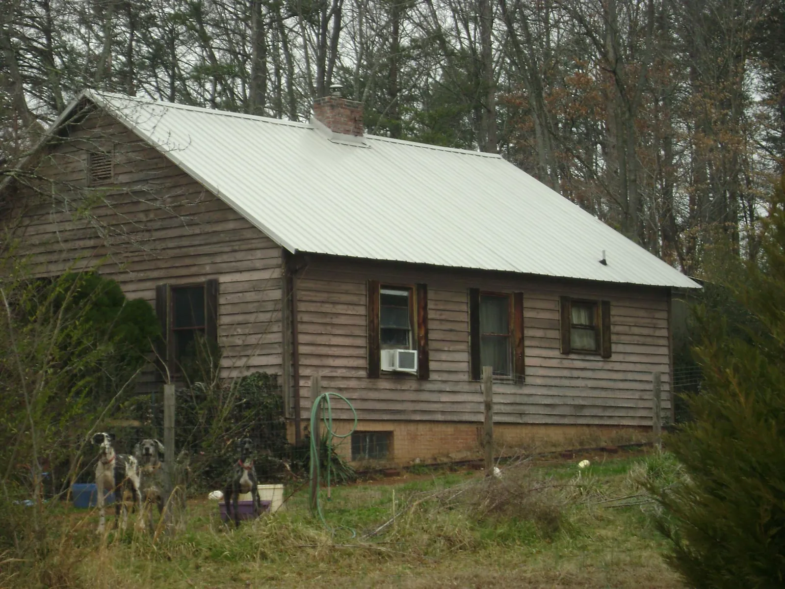 White metal roof on an old wood sided farmhouse, from a Metal Roof Installation job in Hillsborough